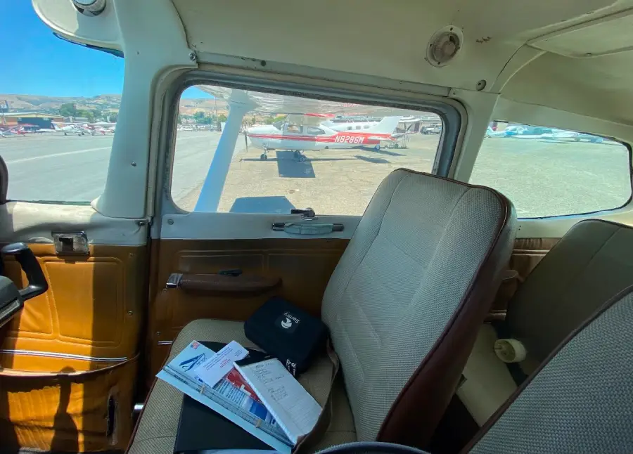 Small airplane cabin interior with brown and tan seats