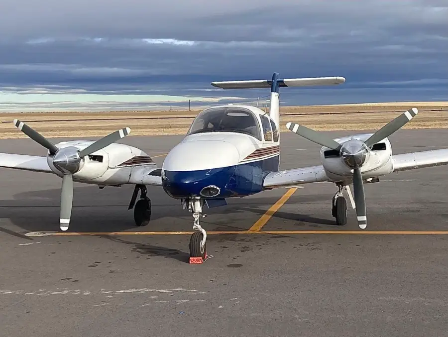Front view of a twin-engine airplane parked on the tarmac