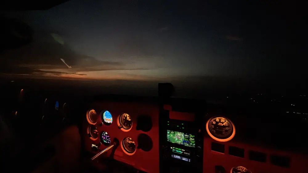 Illuminated aircraft cockpit panel glowing warmly at night