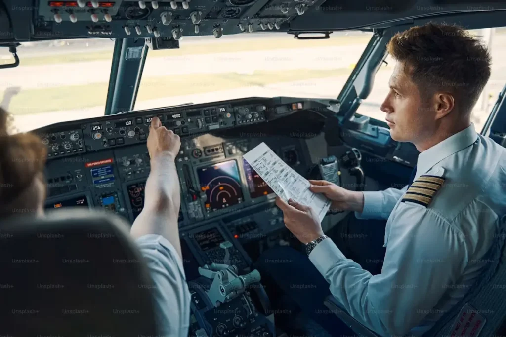 Pilots checking instruments in the cockpit.